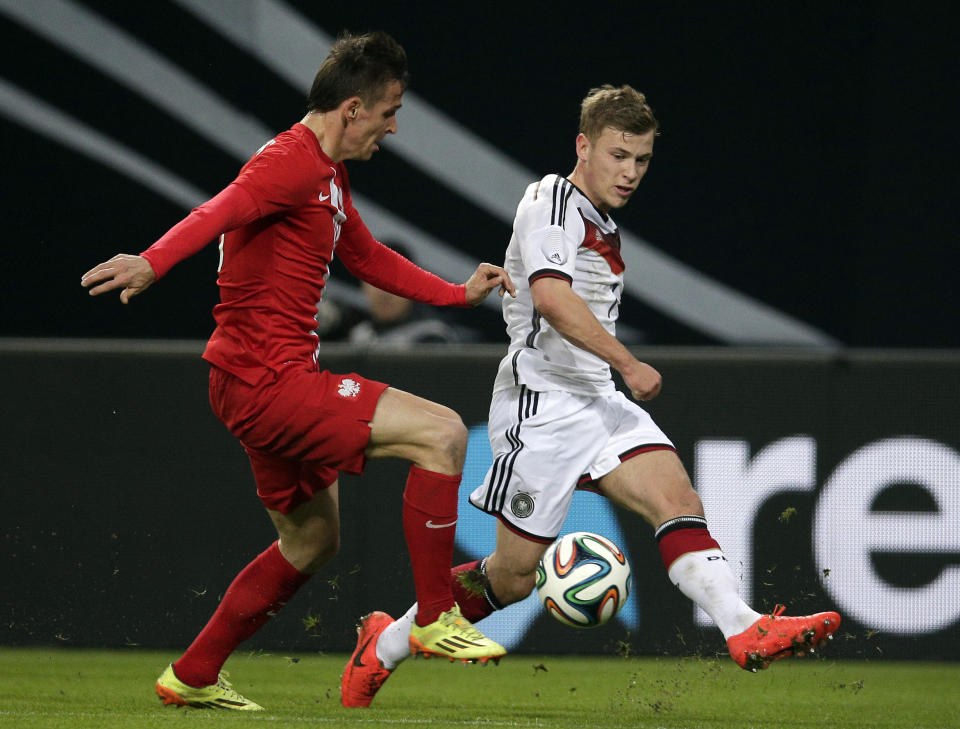 Germany's Max Meyer, right, and Poland's Pawel Olkowski, left, challenge for the ball during a friendly soccer match between Germany and Poland in Hamburg, Germany, Tuesday, May 13, 2014. (AP Photo/Michael Sohn)