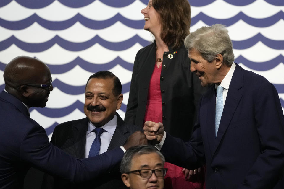 The United States Special Presidential Envoy for Climate John Kerry, right, greets other representatives taking part in a group photo at the United Nations Ocean Conference in Lisbon, Monday, June 27, 2022. From June 27 to July 1, the United Nations is holding its Oceans Conference in Lisbon expecting to bring fresh momentum for efforts to find an international agreement on protecting the world's oceans. (AP Photo/Armando Franca)