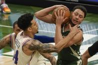 Philadelphia 76ers' Danny Green fouls Milwaukee Bucks' Bryn Forbes during the first half of an NBA basketball game Saturday, April 24, 2021, in Milwaukee. (AP Photo/Morry Gash)