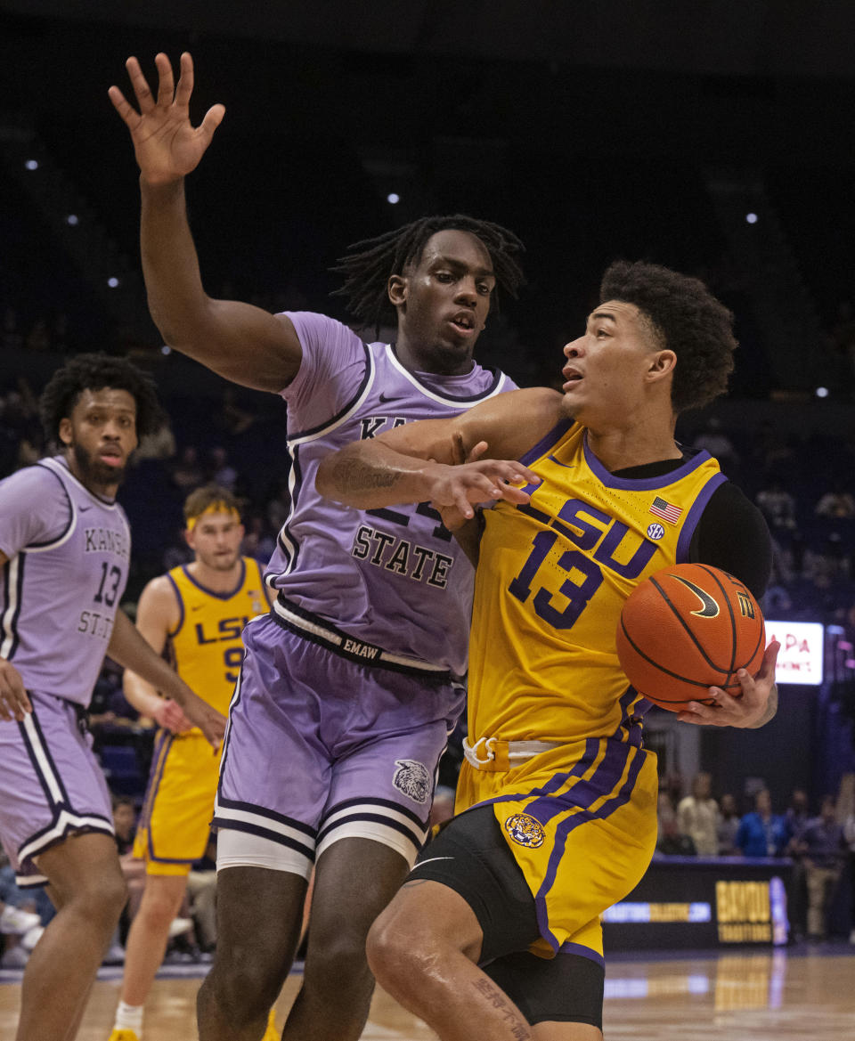 LSU forward Jalen Reed (13) drives around Kansas State forward Arthur Kaluma (24),during an NCAA college basketball game, Saturday, Dec. 9, 2023, at the LSU PMAC in Baton Rouge, La. (Hilary Scheinuk/The Advocate via AP)