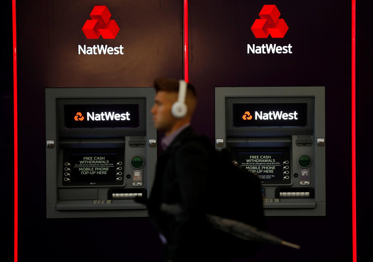 A man walks past ATM machines at branch of the NatWest bank in Manchester, Britain September 21, 2017. Picture taken September 21, 2017.    REUTERS/Phil Noble