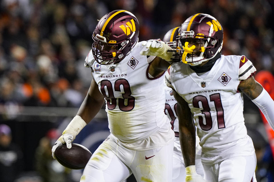 Washington Commanders defensive tackle Jonathan Allen celebrates an interception against the Chicago Bears with safety Kam Curl in the first half of an NFL football game in Chicago, Thursday, Oct. 13, 2022. (AP Photo/Nam Y. Huh)