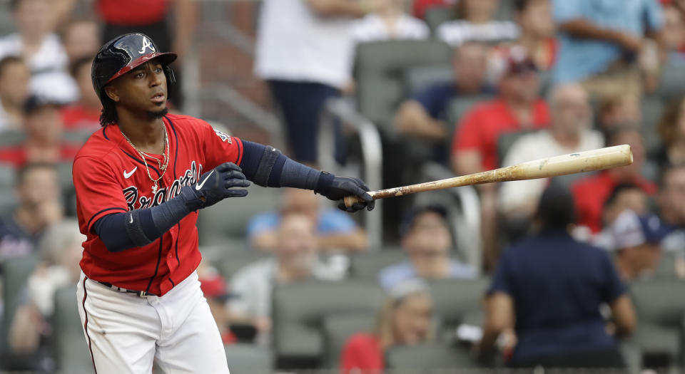 Atlanta Braves' Ozzie Albies swings for an RBI-sacrifice fly off Miami Marlins pitcher Ross Detwiler in the first inning of a baseball game Friday, July 2, 2021, in Atlanta. (AP Photo/Ben Margot)