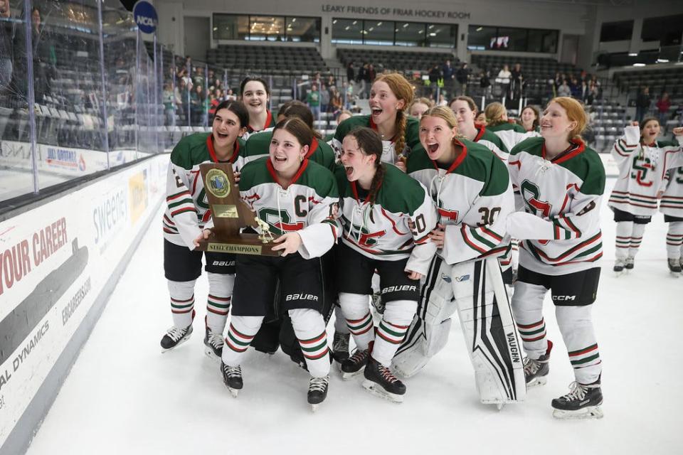 The Smithfield/Coventry/Moses Brown girls hockey co-op team celebrates its state championship on Saturday night. SCMB defeated La Salle, 3-2, in overtime for the title.