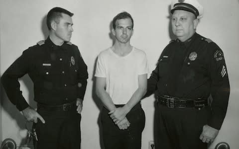 Lee Harvey Oswald in custody - Credit: Reuters