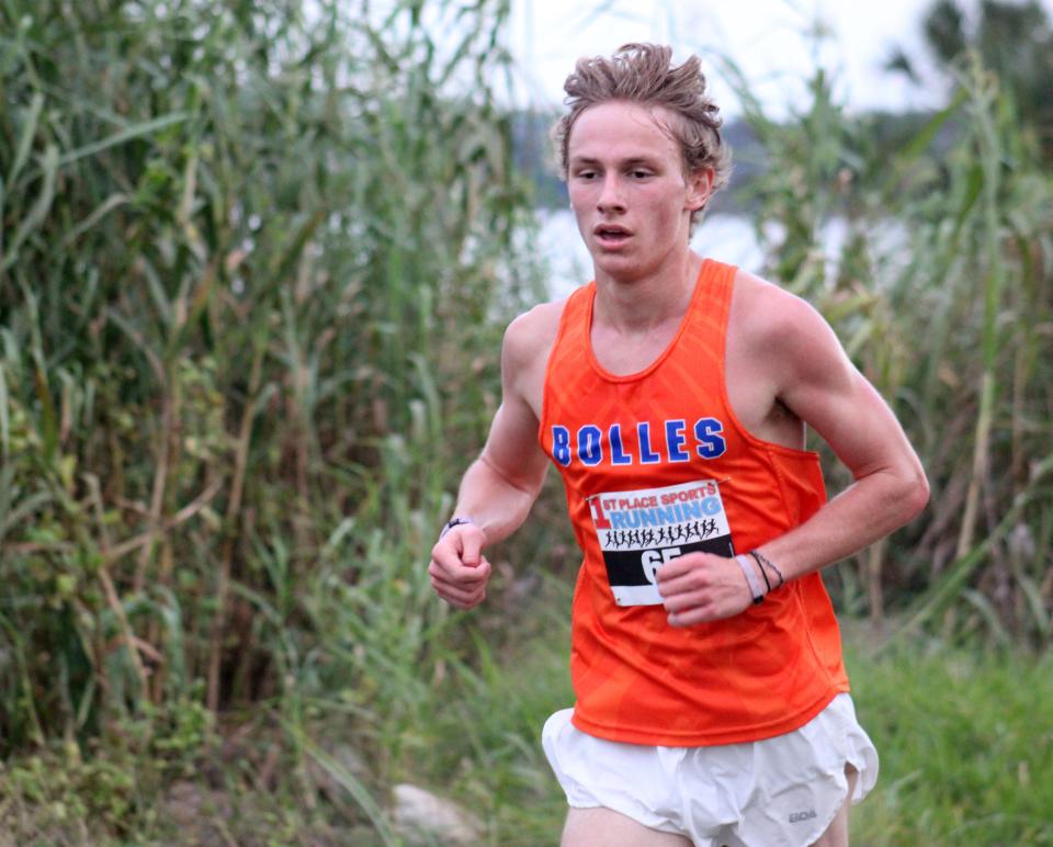 Bolles senior Aidan Ryan (65) leads the field along the St. Johns River during the final mile of  the Florida High School Athletic Association District 2-2A cross country meet at Bishop Kenny High School on October 17, 2022. [Clayton Freeman/Florida Times-Union]