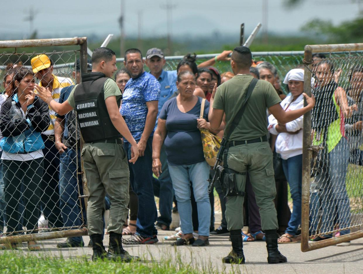 Relatives of inmates gather outside the Fenix Penitentiary following a riot: Getty