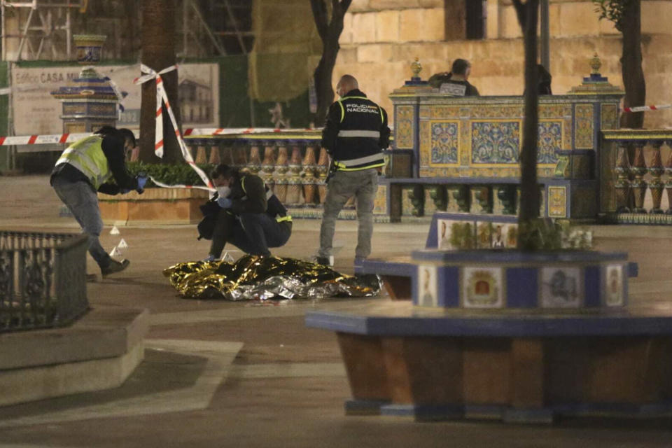 Police work next to the body of a man killed in Algeciras, southern Spain, Wednesday, Jan. 25, 2023. Spain's interior ministry says that one person has been killed and another serious injured in an attack carried out by a person with a bladed weapon at a church in the southern city of Algeciras on Wednesday. The attacker has been arrested and is in custody of Spain's National Police. (Nono Rico/Europa Press via AP)