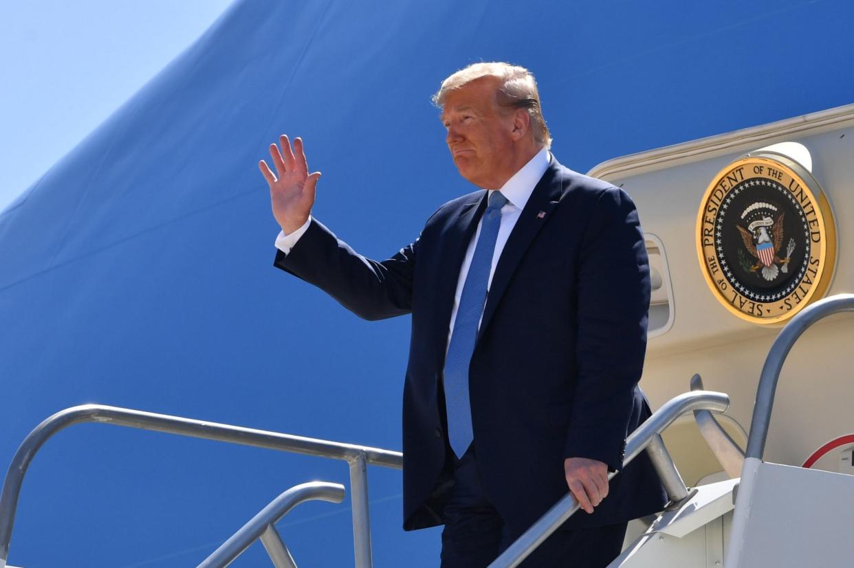 Donald Trump waves as he exits Marine One: Getty