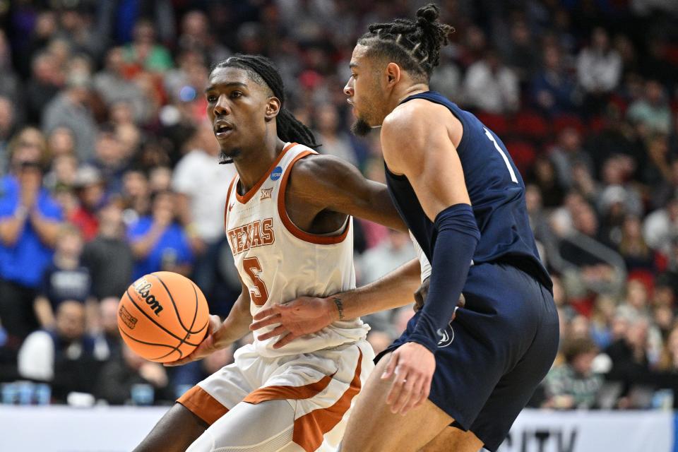 Texas guard Marcus Carr, left, drives against Penn State guard Seth Lundy during a 71-66 victory over the Penn State in a NCAA Tournament second-round game at Wells Fargo Arena in Des Moines. With the win, Carr and the Longhorns advanced to the Sweet 16 for the first time in 15 years.