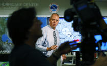 Ken Graham, center, director of the National Hurricane Center speaks during a broadcast, Tuesday, Sept. 4, 2018, at the hurricane center in Miami. Boaters evacuated to safe harbors, and motorists fled barrier islands Tuesday as the Gulf Coast hustled to get ready for Tropical Storm Gordon, which was on track to hit Mississippi as a Category 1 hurricane sometime after nightfall. (AP Photo/Wilfredo Lee)