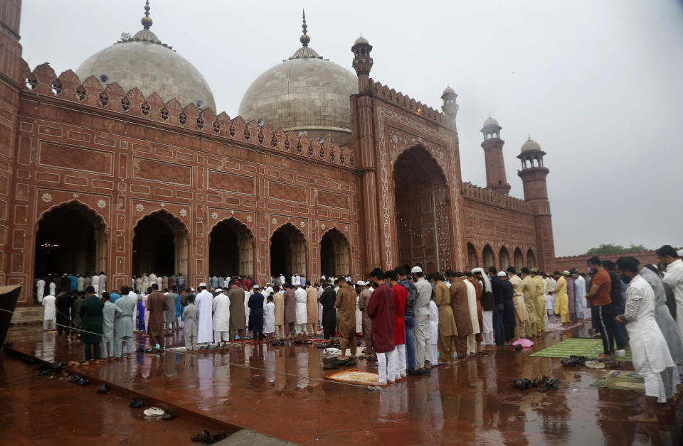 Muslims perform an Eid al-Fitr prayer at historical Badshahi mosque, in Lahore, Pakistan, Thursday, May 13, 2021. Millions of Muslims across the world are marking a muted and gloomy holiday of Eid al-Fitr, the end of the fasting month of Ramadan, a usually joyous three-day celebration that has been significantly toned down as coronavirus cases soar. (AP Photo/K.M. Chaudary)