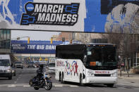 The Florida basketball team is escorted to Hinkle Fieldhouse for the NCAA college basketball tournament, Wednesday, March 17, 2021, in Indianapolis. (AP Photo/Darron Cummings)