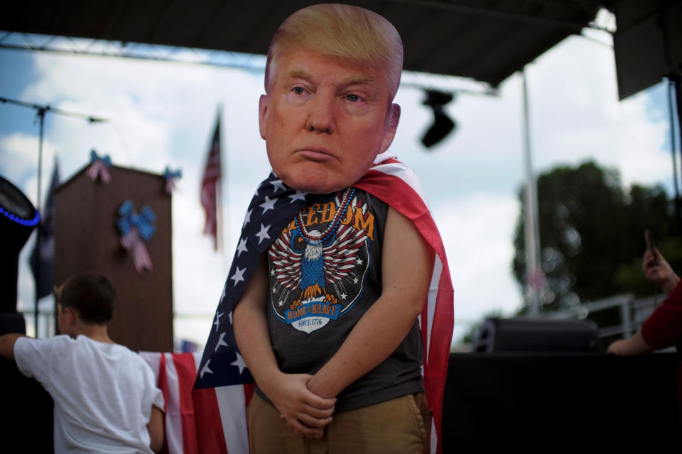 <p>A rally attendee wears a mask depicting the face of U.S. President Donald Trump at the Mother of All Rallies on the National Mall in Washington, Sept. 16, 2017. (Photo: James Lawler Duggan/Reuters) </p>