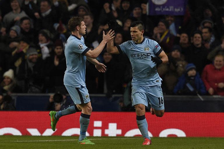 Manchester City's Sergio Aguero (R) celebrates with teammate James Milner after scoring during the Champions League match against Barcelona in Manchester on February 24, 2015