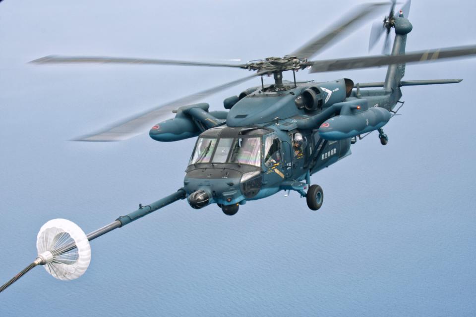 A Japan Air Self Defense Force (JASDF) UH-60J, seen here linking up with a US Air Force MC-130 special operations tanker transport during training. <em>USAF</em>