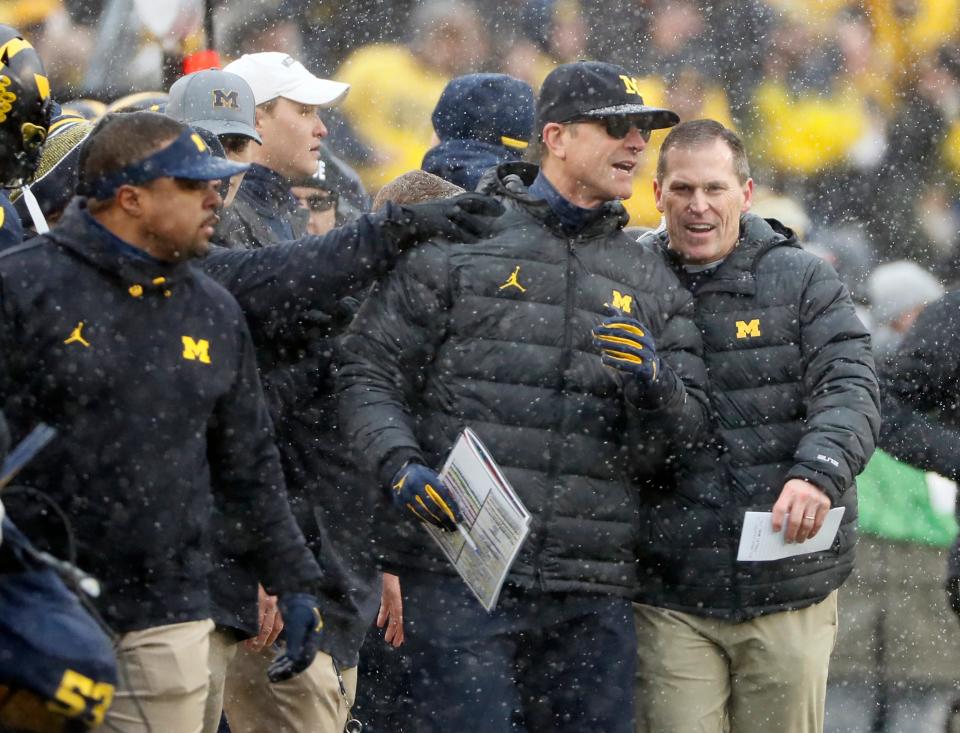 Michigan Wolverines head coach Jim Harbaugh celebrates on the sideline after beating Ohio State Buckeyes 42-27 in a NCAA College football at Michigan Stadium at Ann Arbor, Mi on November  27, 2021. 