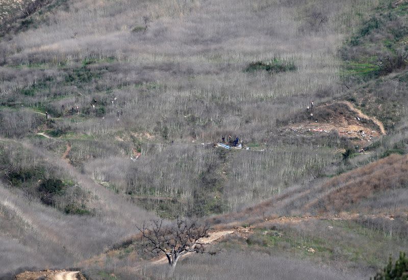 Investigators work at the scene of the helicopter crash which killed NBA star Kobe Bryant in Calabasas