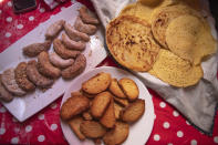 Moroccan sweets are displayed on a table inside the home of Ghita Naoui as she and her relatives spend Eid in lockdown due to the Coronavirus pandemic, in Sale, Morocco, Sunday, May 24, 2020. (AP Photo/Mosa'ab Elshamy)