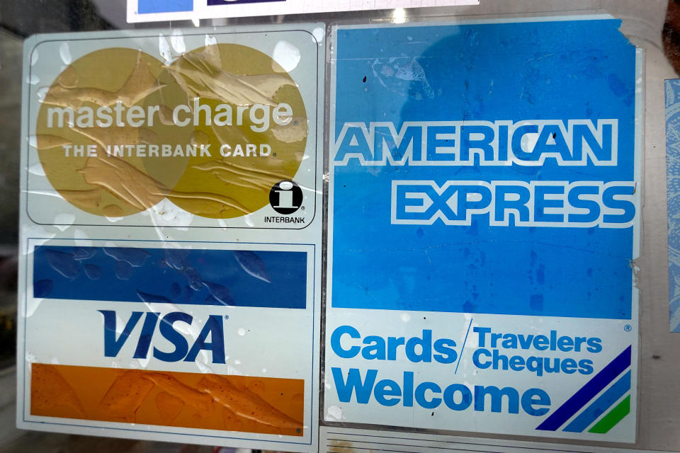 CHICAGO, ILLINOIS - JANUARY 24: A sticker pasted at the entrance of a business lets customers know that they accept American Express credit cards on January 24, 2020 in Chicago, Illinois. American Express today reported better-than-expected fourth-quarter earnings attributed to growing card fee revenues. (Photo by Scott Olson/Getty Images)