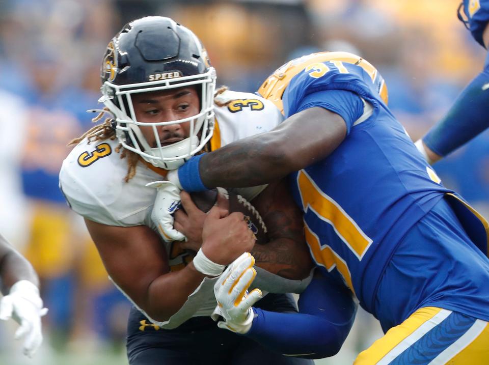 Kent State running back Ky Thomas (3) runs the ball against Pittsburgh linebacker Rasheem Biles (31) during the third quarter Saturday in Pittsburgh.