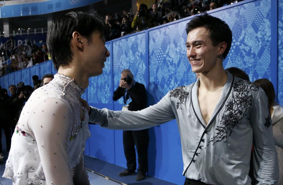 Hanyu speaks with Chan before the flower ceremony during the Figure Skating Men's Free Skating Program at the Sochi 2014 Winter Olympics