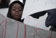 <p>Kevin Etienne holds up a sign as he listens to a news conference condemning President Trump’s recent remarks denigrating Haiti, before a march to commemorate the eighth anniversary of the Haitian earthquake, Friday, Jan. 12, 2018, in Miami, Fla. (Photo: Wilfredo Lee/AP) </p>