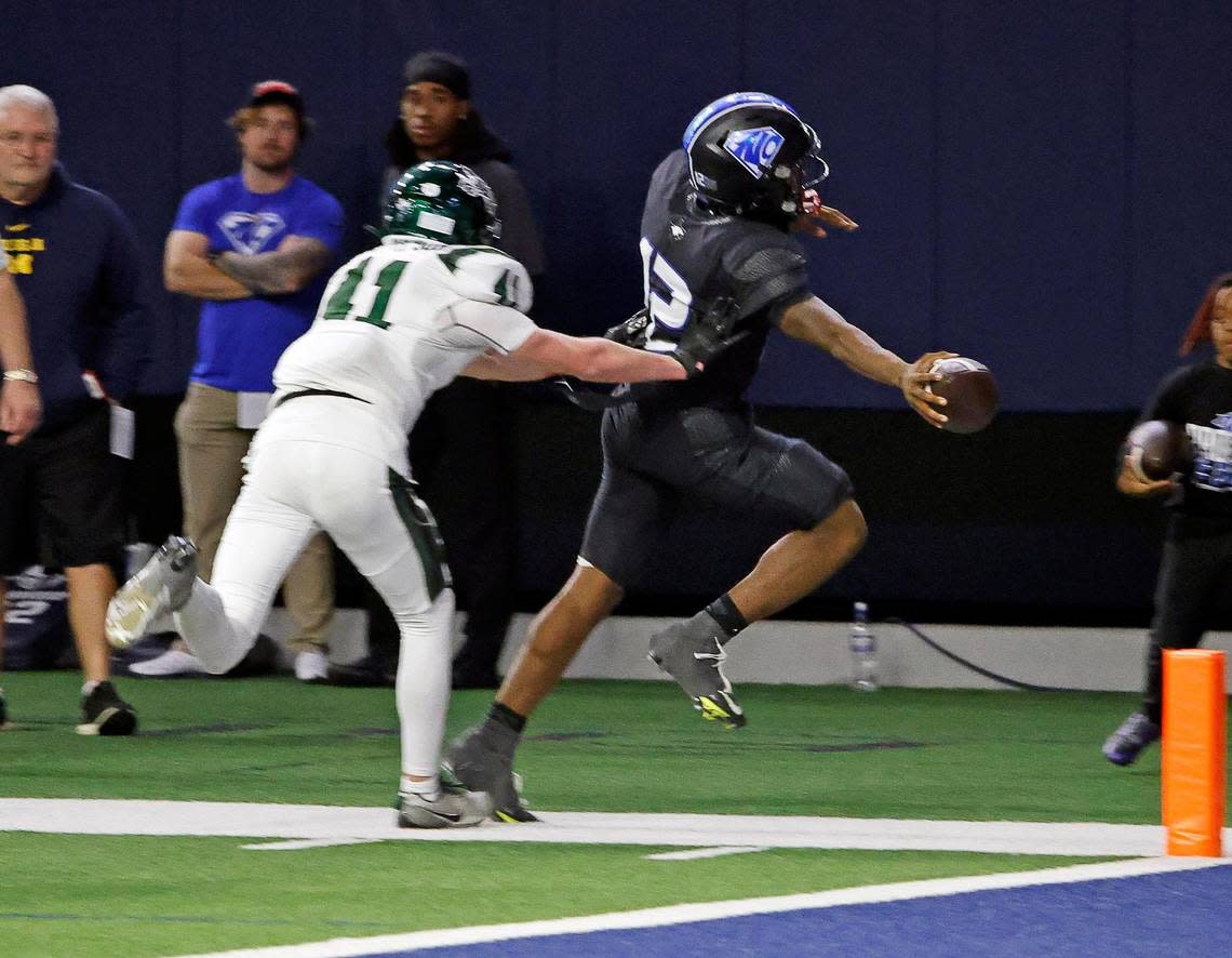 Prosper strong safety Trevor Ellis (11) pushes North Crowley quarterback Chris Jimerson (12) out of bounds close to the goal line in the second half of a UIL Class 6A Division 1 football regional-round playoff game at The Ford Center in Frisco, Texas, Saturday, Oct. 25, 2023.