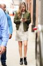 <p>The model looked chic in an embellished dress with distressed touches, paired with an on-trend olive green bomber jacket and black booties. </p>