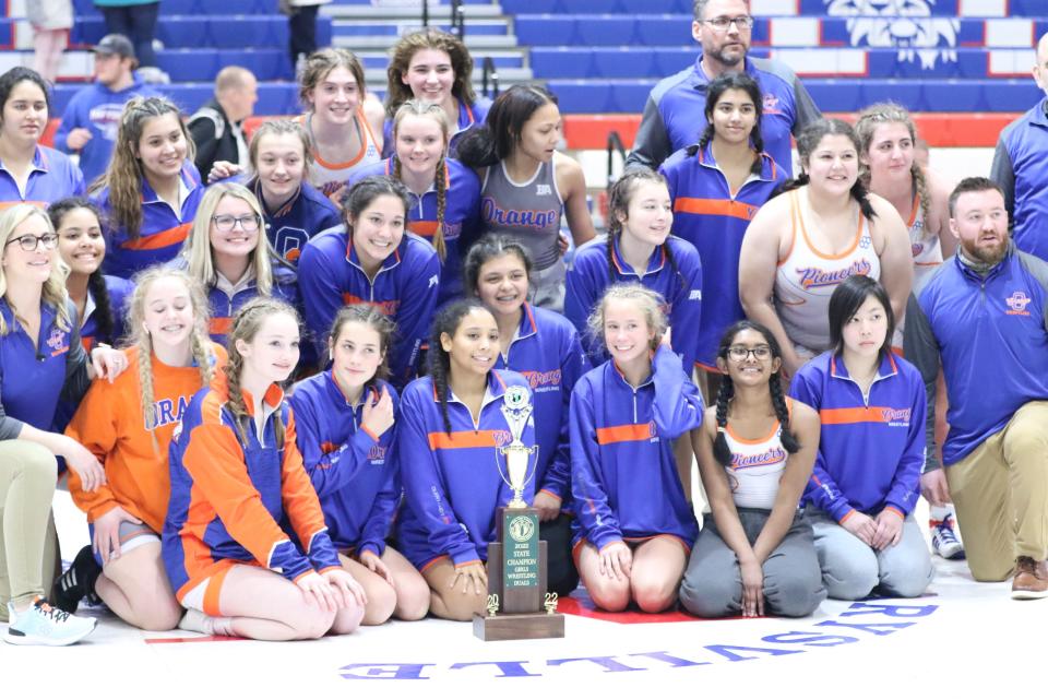 The Olentangy Orange girls wrestling team poses with the trophy after winning the OHSWCA state dual championship Jan. 23 at Marysville.