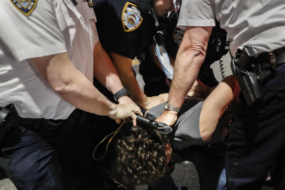 Police arrest a protester on Fifth Avenue during a march Thursday, June 4, 2020, in the Manhattan borough of New York. Protests continued following the death of George Floyd, who died after being restrained by Minneapolis police officers on May 25. (AP Photo/John Minchillo)