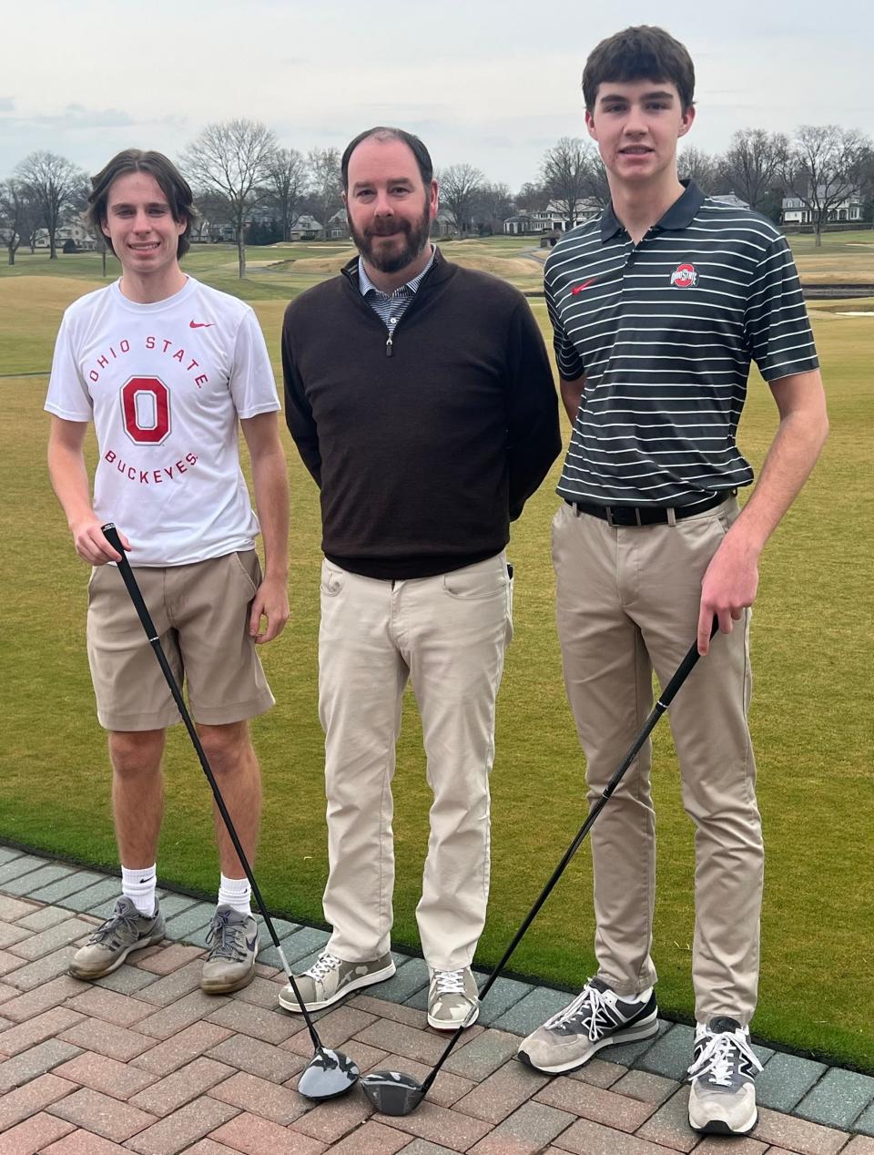 St. Charles senior Sam Martin, left, and Hilliard Davidson senior Ryder Wilson, right, have earned caddie scholarships and will attend Ohio State. They are pictured with Jason Dick, a member of the Chick Evans Scholarship committee at Scioto Country Club, where Martin and Wilson work as caddies.
