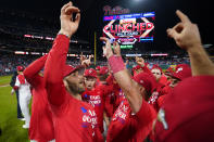 Philadelphia Phillies' Bryce Harper celebrates with teammates after their win in a baseball game against the Pittsburgh Pirates to clinch a wild-card playoff spot, Tuesday, Sept. 26, 2023, in Philadelphia. (AP Photo/Matt Slocum)