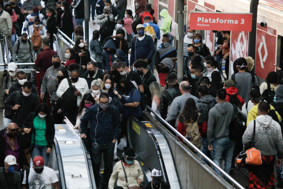 Passengers gather close together waiting to use the station's escalator. Source: Getty