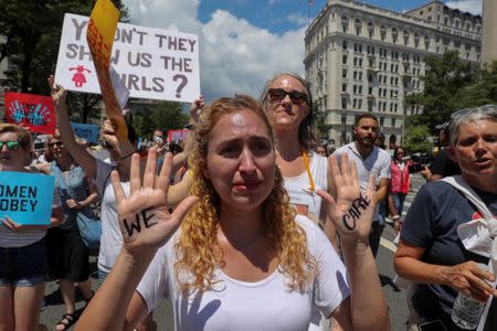 A demonstrator cries as she joins a rally and march calling for "an end to family detention" and in opposition to the immigration policies of the Trump administration in Washington, U.S. June 28, 2018. REUTERS/Jonathan Ernst