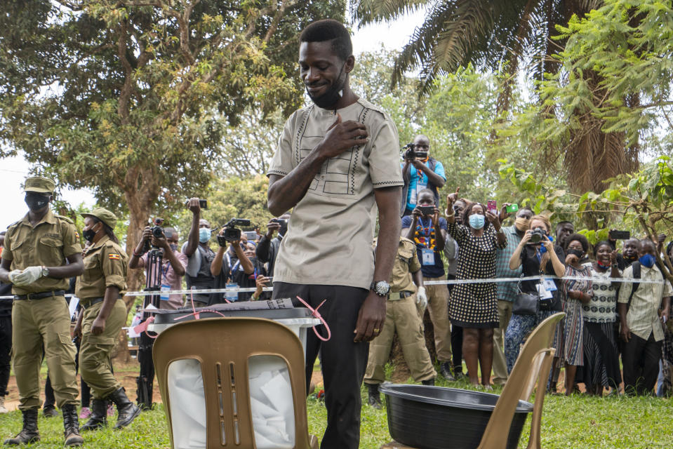 Uganda's leading opposition challenger Bobi Wine makes the sign of the cross after voting in Kampala, Uganda, Thursday, Jan. 14, 2021. Ugandans are voting in a presidential election tainted by widespread violence that some fear could escalate as security forces try to stop supporters of Wine from monitoring polling stations.(AP Photo/Jerome Delay)