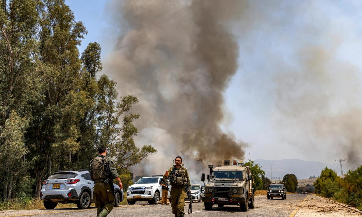 <span>A smoke plume rises after rockets fired from southern Lebanon landed near Kfar Szold in the Upper Galilee in northern Israel on 14 June.</span><span>Photograph: Jalaa Marey/AFP/Getty Images</span>