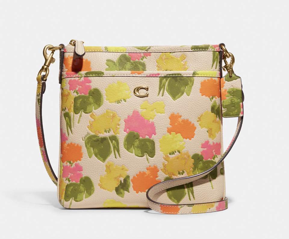 Kitt Messenger Crossbody With Floral Print. Image via Coach Outlet.