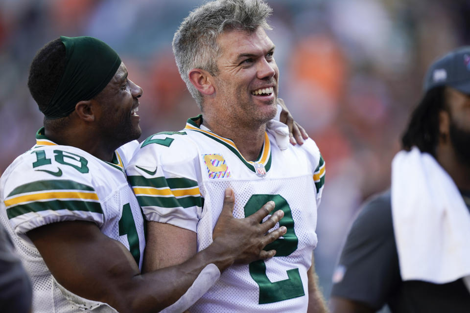 Green Bay Packers kicker Mason Crosby (2) is congratulated by wide receiver Randall Cobb (18) after kicking the winning field goal during overtime in an NFL football game against the Cincinnati Bengals in Cincinnati, Sunday, Oct. 10, 2021. The Packers defeated the Bengals 25-22 in overtime. (AP Photo/Bryan Woolston)