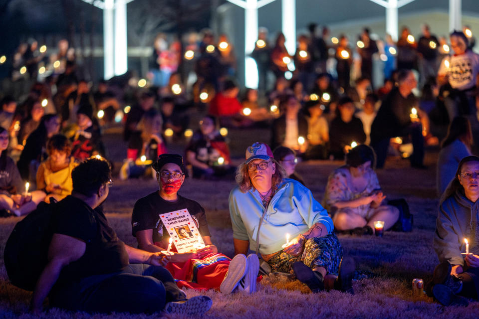 Miranda Searcy sits with hundreds of others during a vigil on Sunday at Redbud Festival Park for Nex Benedict, the Owasso teen who died earlier in February, one day after they were hospitalized for injuries suffered in a school fight in Owasso.