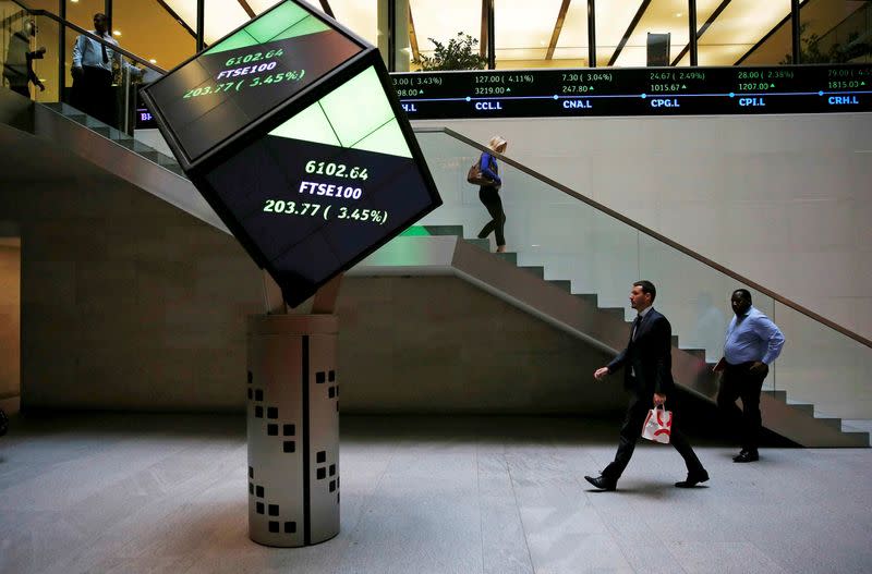 FILE PHOTO: People walk through the lobby of the London Stock Exchange in London