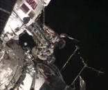 Russian astronaut Oleg Kotov (R) holds an Olympic torch beside Russian astronaut Sergei Ryazansky outside the International Space Station in this still image taken from video courtesy of NASA TV, November 9, 2013. A pair of Russian cosmonauts took the Olympic torch into open space for the first time in history on Saturday as part of the torch relay of the Sochi 2014 Winter Games. REUTERS/NASA TV/Handout via Reuters (OUTER SPACE - Tags: ENVIRONMENT SPORT OLYMPICS SCIENCE TECHNOLOGY) ATTENTION EDITORS - THIS IMAGE WAS PROVIDED BY A THIRD PARTY. FOR EDITORIAL USE ONLY. NOT FOR SALE FOR MARKETING OR ADVERTISING CAMPAIGNS. THIS PICTURE IS DISTRIBUTED EXACTLY AS RECEIVED BY REUTERS, AS A SERVICE TO CLIENTS