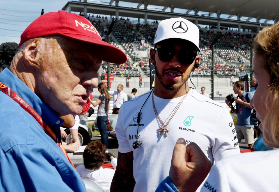 Lewis Hamilton listens to F1 legend Niki Lauda prior to his drivers' parade during the Formula One Japanese Grand Prix at Suzuka on October 8, 2017. (Photo by TOSHIFUMI KITAMURA/AFP/Getty Images)