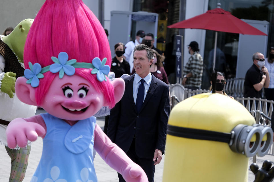 California Governor Gavin Newsom arrives to a news conference at Universal Studios in Universal City, Calif., on Tuesday, June 15, 2021. Starting Tuesday, there were no more state rules on social distancing, and no more limits on capacity at restaurants, bars, supermarkets, gyms, stadiums or anywhere else. (AP Photo/Ringo H.W. Chiu)