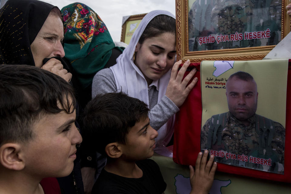 People attend funerls of Syrian Democratic Forces fighters killed recently fighting Turkish forces in the town of Hasakeh, north Syria, Monday, Oct. 21, 2019. (AP Photo/Baderkhan Ahmad)