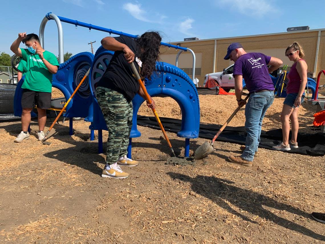 Volunteers including Marty Taylor, a former Dillow Elementary School student, helped to construct a new playground designed by students with parent and community input.