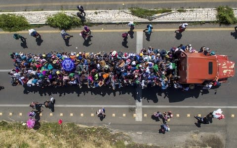 Aerial view of Honduran migrants onboard a truck  - Credit: Pedro Pardo/AFP