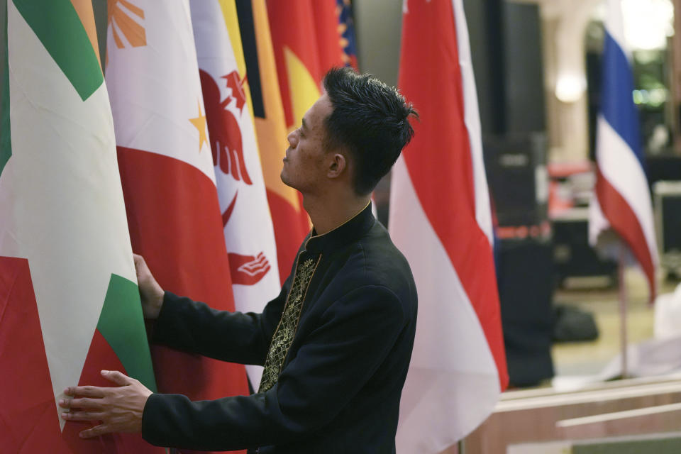 An Indonesian worker prepares the flags of the member countries of the Association of Southeast Asian Nations (ASEAN) in Jakarta, Indonesia, Monday, July 10, 2023. Myanmar's prolonged civil strife, tensions in the disputed South China Sea and concern over arms buildups in the region are expected to dominate the agenda when Southeast Asia's top diplomats gather for talks this week in Indonesia. (AP Photo/Achmad Ibrahim)