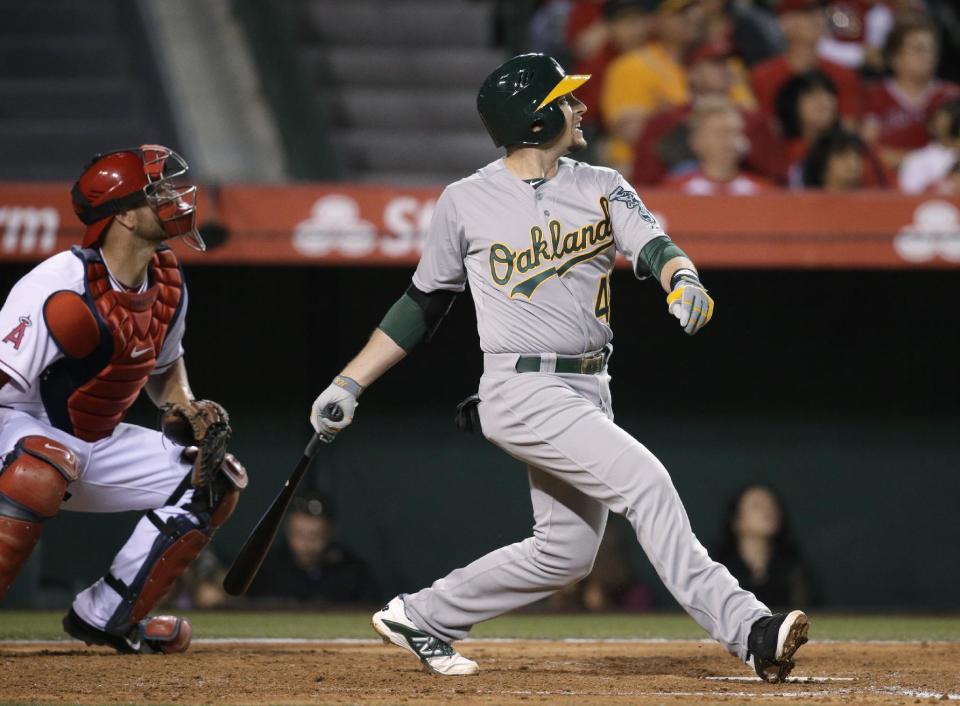 Oakland Athletics' Jed Lowrie watches his RBI double during the third inning of a baseball game against the Los Angeles Angels on Tuesday, April 15, 2014, in Anaheim, Calif. (AP Photo/Jae C. Hong)