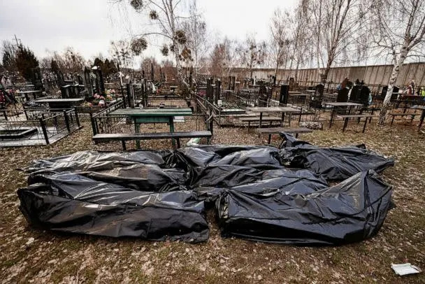 PHOTO: Bags containing bodies of civilians are seen at the cemetery after being picked up from the streets before they are taken to the morgue, amid Russia's invasion of Ukraine, in Bucha, Ukraine April 4, 2022. (Zohra Bensemra/Reuters)